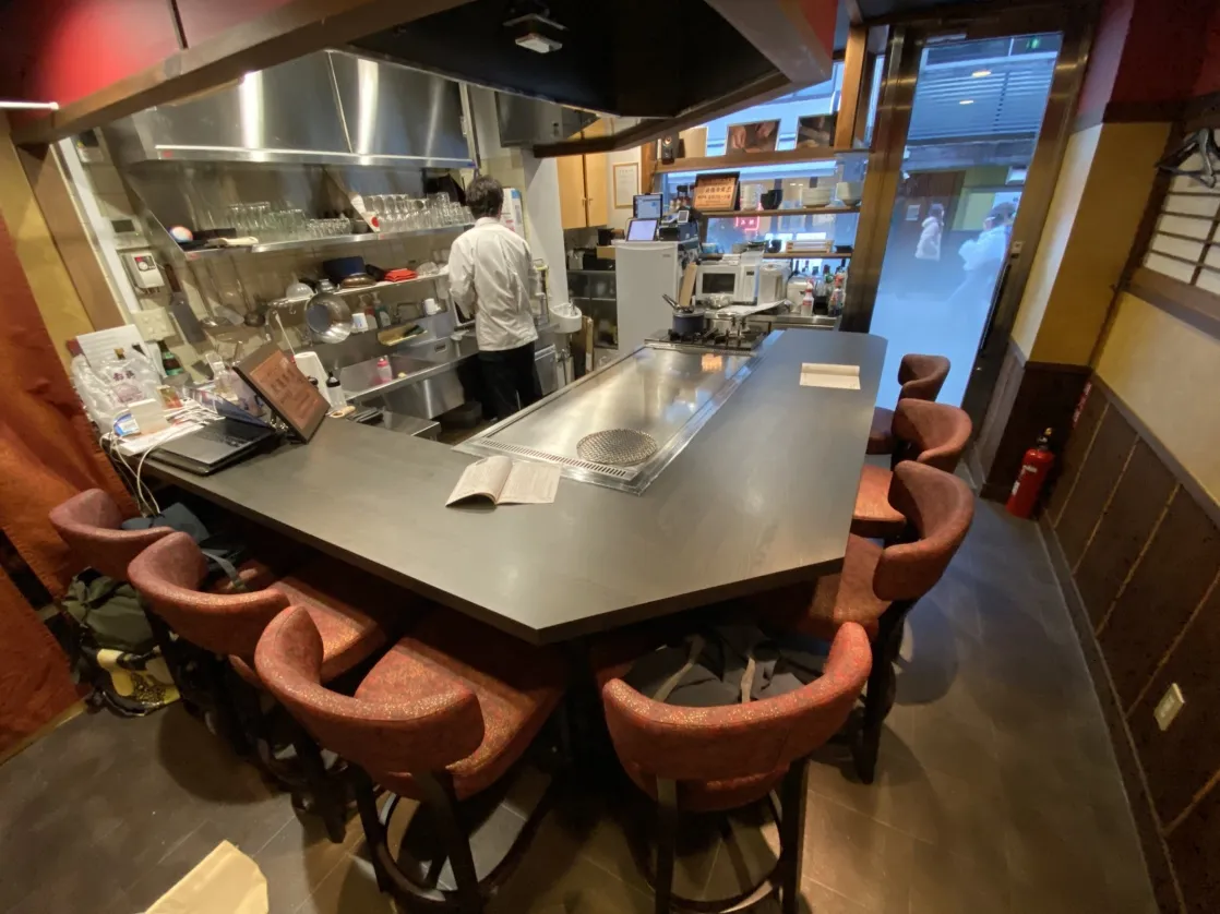The teppan counter by the window, with the kitchen behind