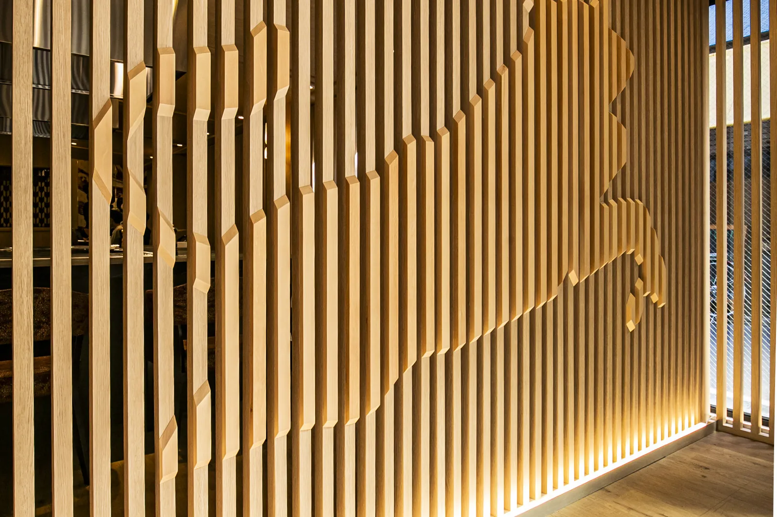 The wooden lattice wall picked out by the lighting