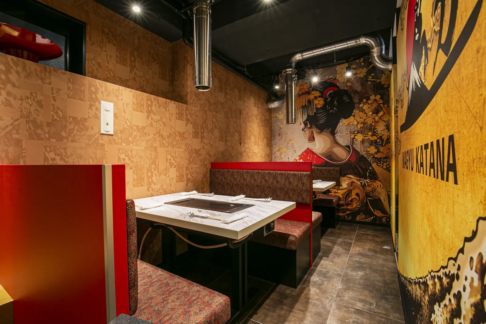 Private room with a red banquette and its own teppan table